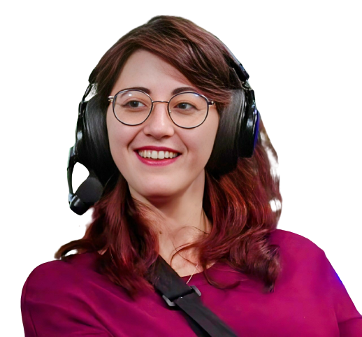 photo of a white woman with short, dark red hair. She is wearing glasses and headphones